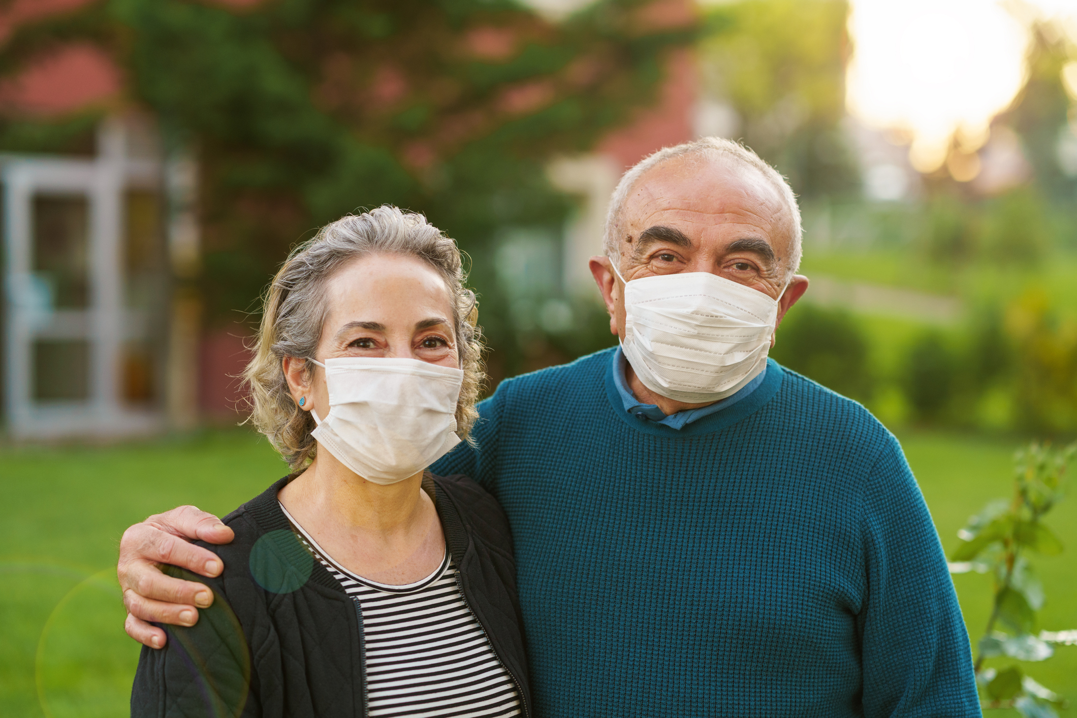 Senior couple on front of their house during COVID-19 quarantine