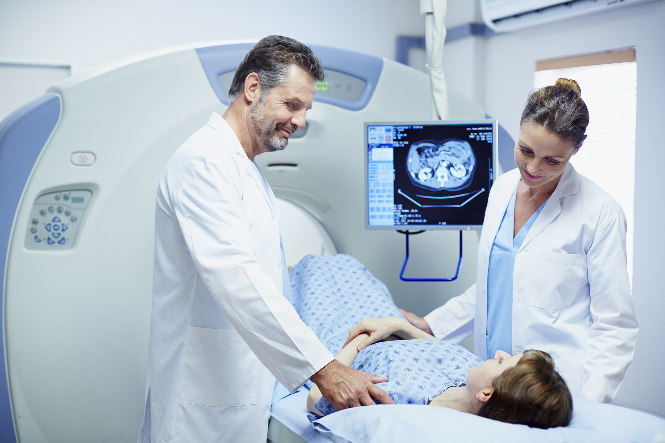 Doctors preparing patient for CT scan in hospital